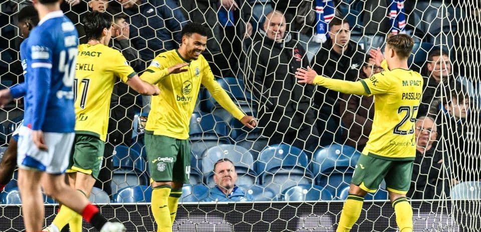 Players celebrating a goal in front of the net Players celebrating a goal in front of the net