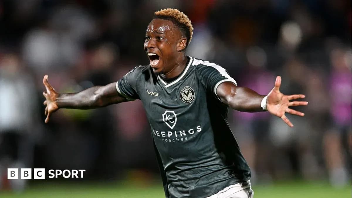 Player celebrating passionately after scoring a goal Player celebrating passionately after scoring a goal