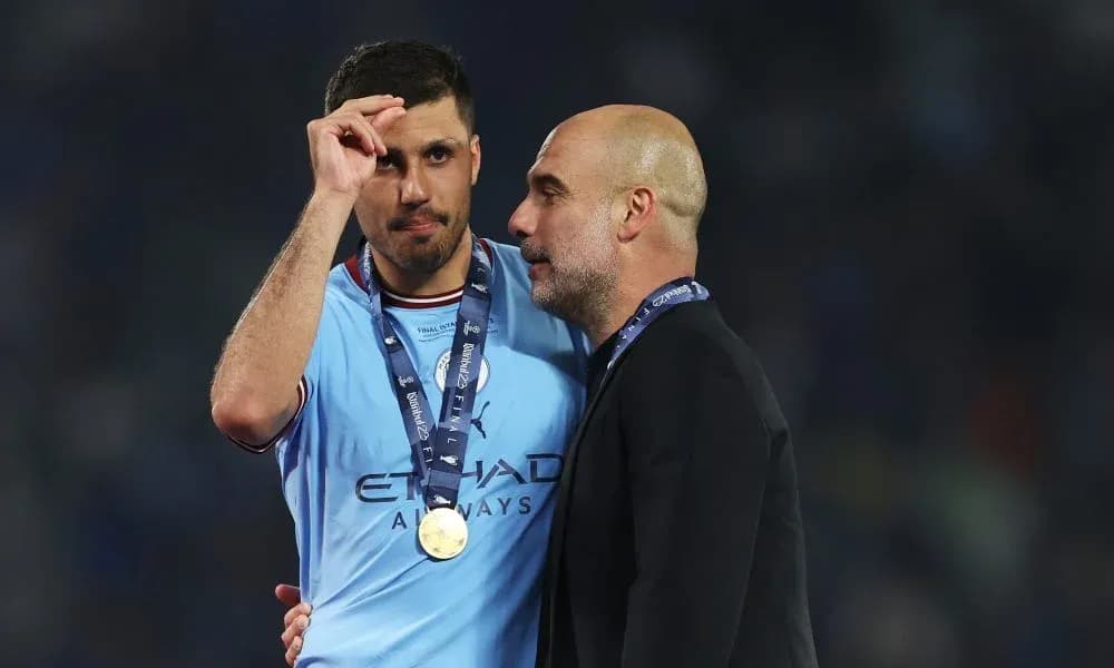 Player and manager celebrating post-match with medals Player and manager celebrating post-match with medals