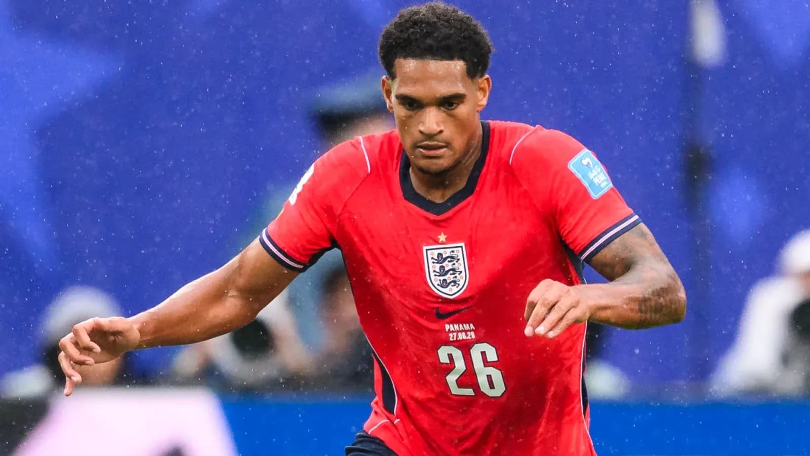 Player in red England kit running during match Player in red England kit running during match