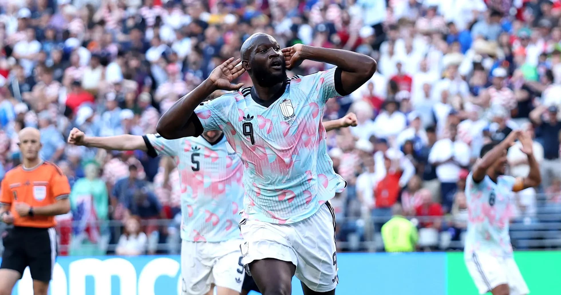 Player celebrating goal with crowd in background Player celebrating goal with crowd in background