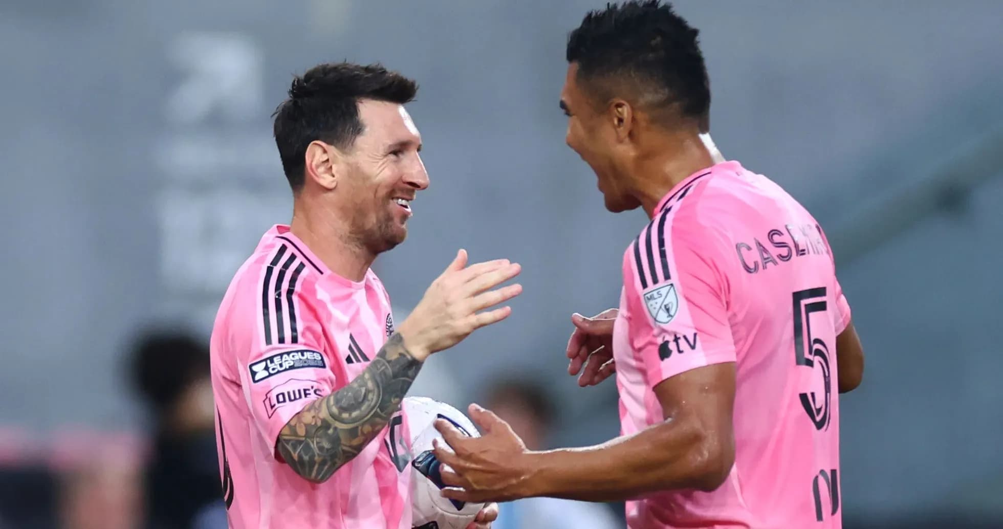 Two players celebrating a goal on the field Two players celebrating a goal on the field