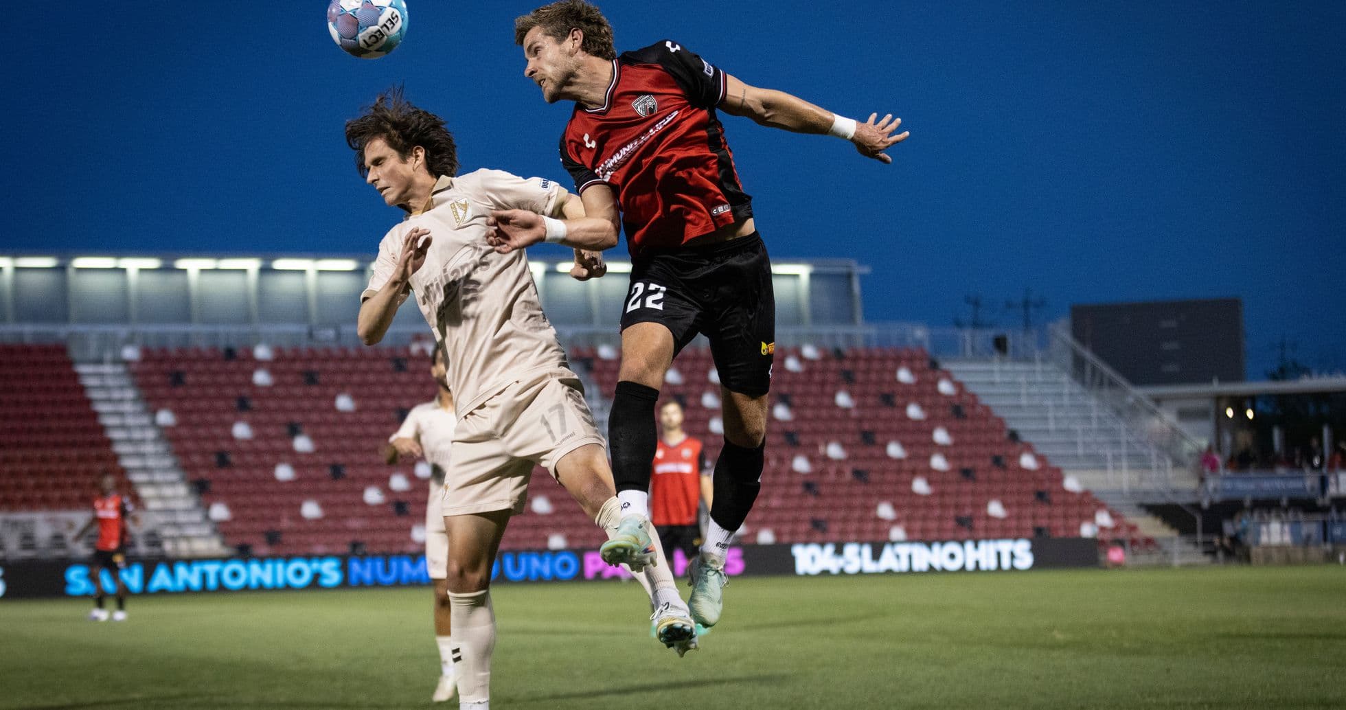 Players competing for the ball in USL match Players competing for the ball in USL match
