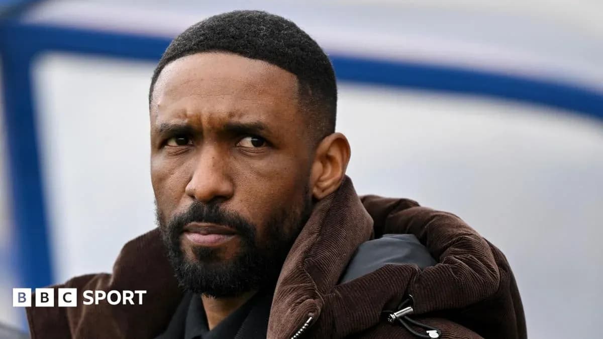 Man with beard wearing a brown jacket, looking thoughtfully Man with beard wearing a brown jacket, looking thoughtfully