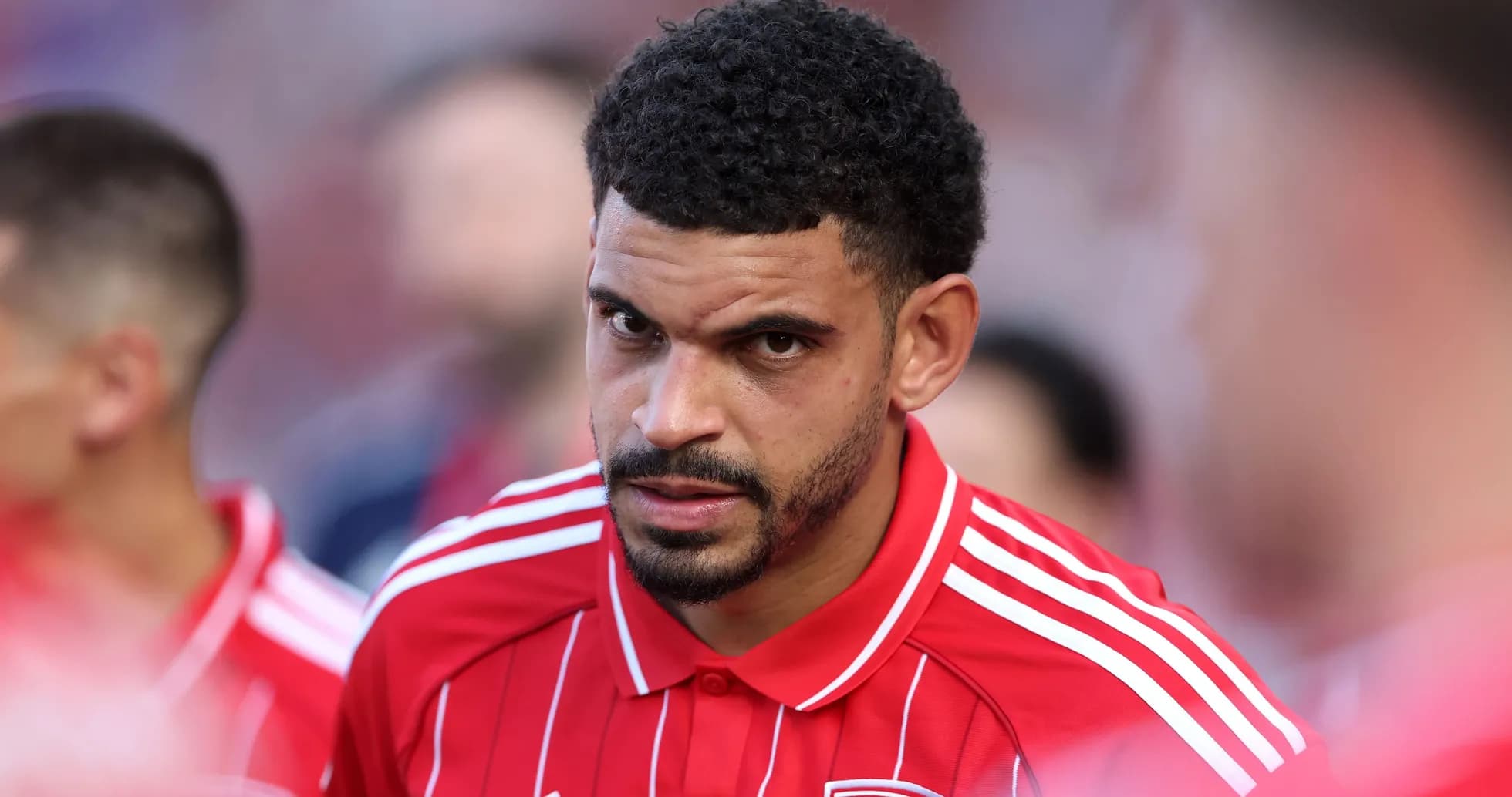 Player in red jersey focused before match Player in red jersey focused before match