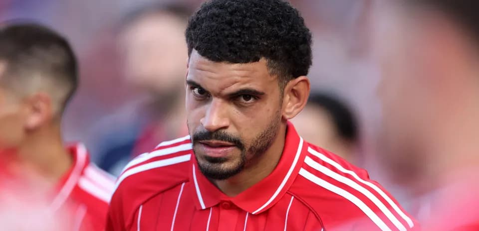 Player in red jersey focused before match Player in red jersey focused before match