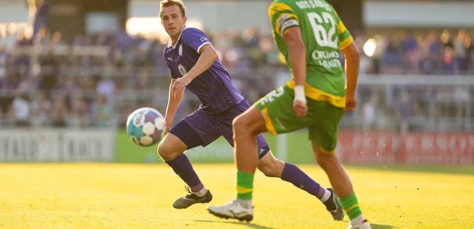 Louisville City player passing the ball during match Louisville City player passing the ball during match