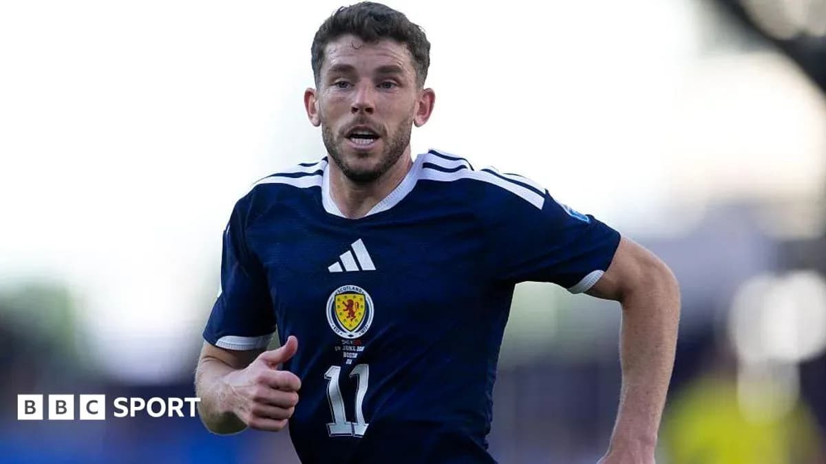 Scottish player running on the pitch during match Scottish player running on the pitch during match