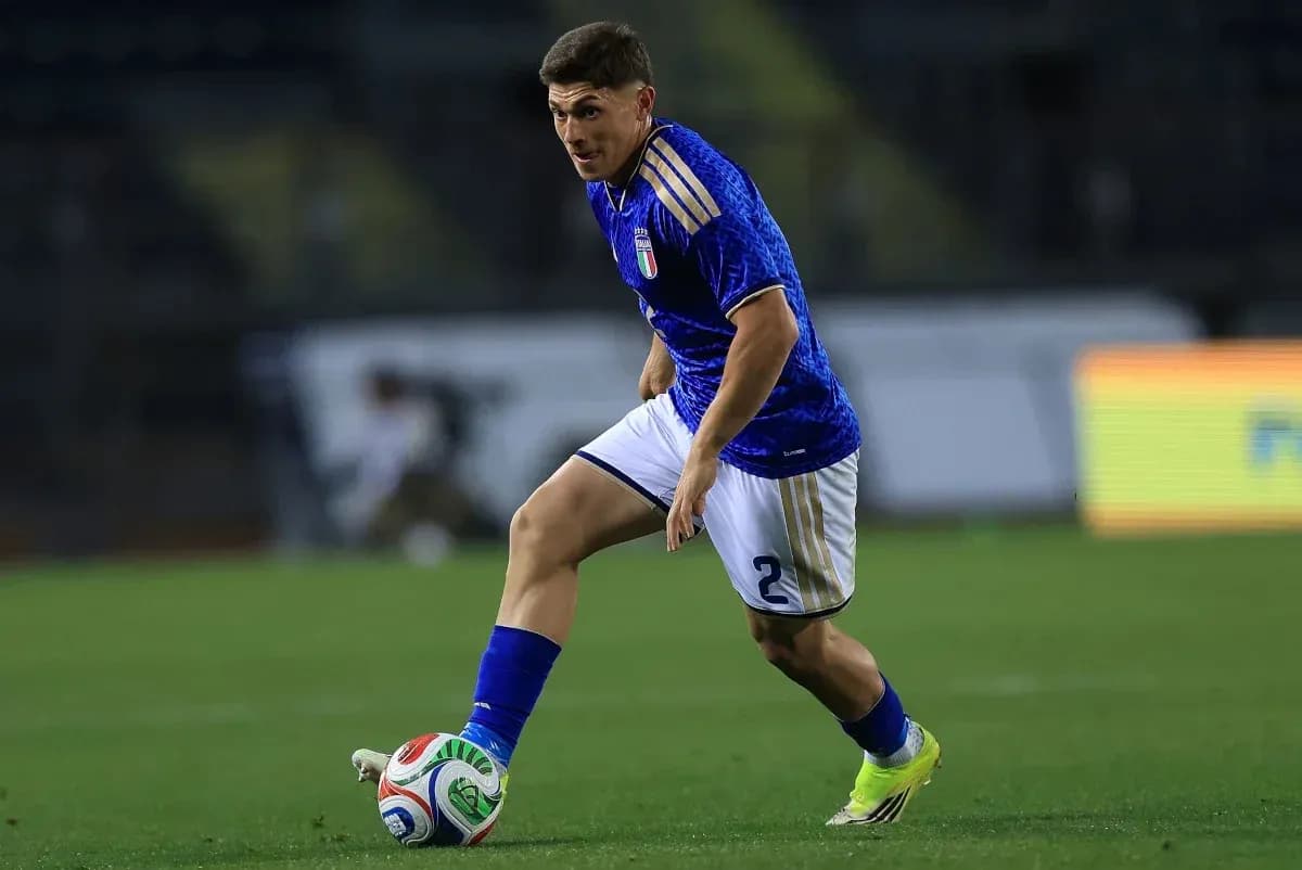 Player in blue jersey dribbling ball on field Player in blue jersey dribbling ball on field