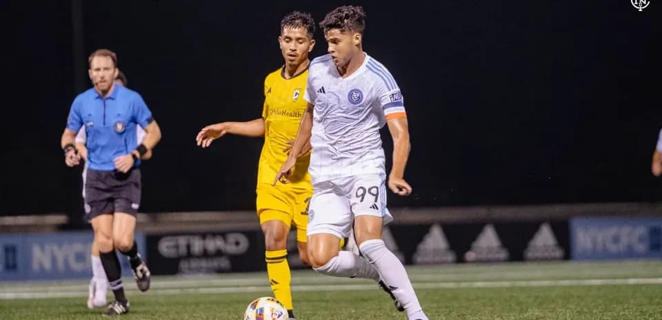 New York City II player dribbling past Columbus Crew II opponent New York City II player dribbling past Columbus Crew II opponent