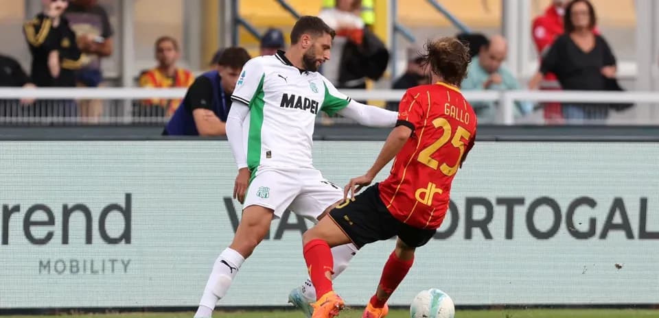 Sassuolo player challenges Lecce opponent for the ball Sassuolo player challenges Lecce opponent for the ball