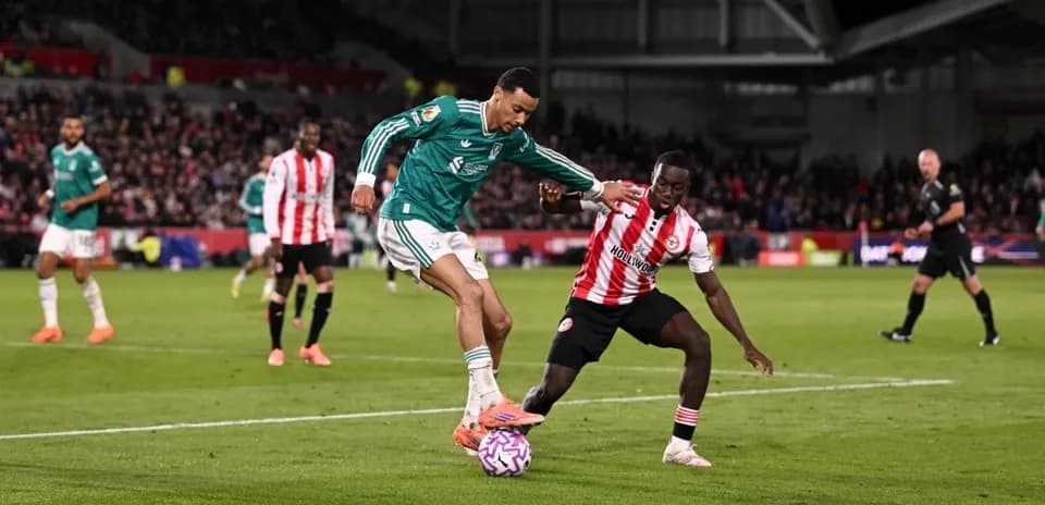 Liverpool player tackling Brentford opponent Liverpool player tackling Brentford opponent