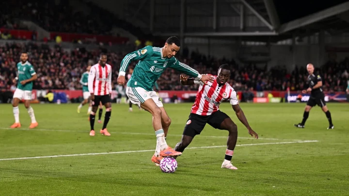 Liverpool player tackling Brentford opponent Liverpool player tackling Brentford opponent