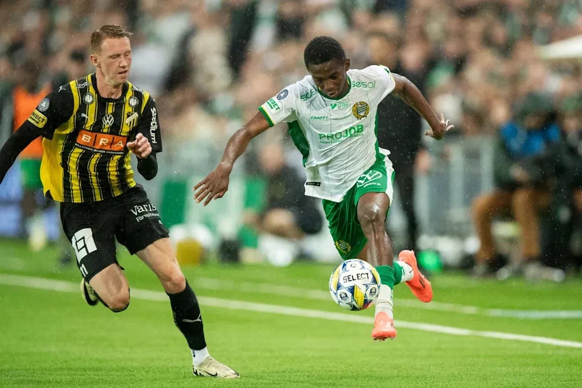 Player in white dribbling past opponent in black Player in white dribbling past opponent in black