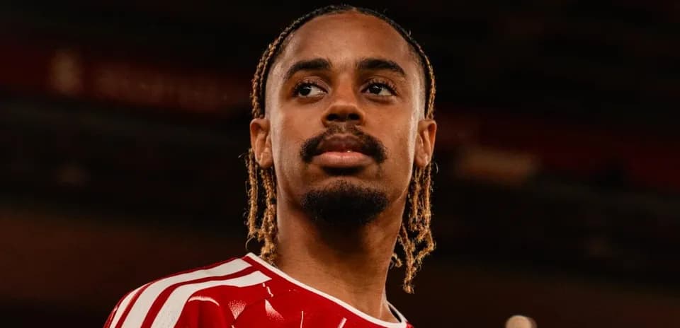Player in red jersey looking into the distance Player in red jersey looking into the distance