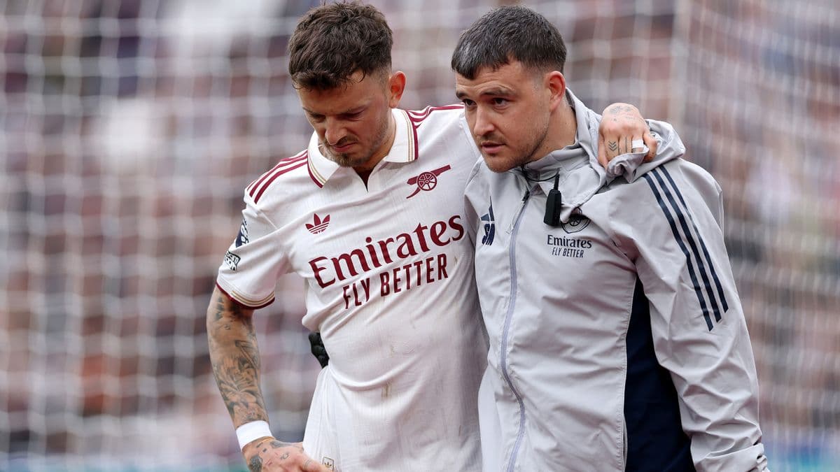 Player receiving assistance from medical staff on field Player receiving assistance from medical staff on field
