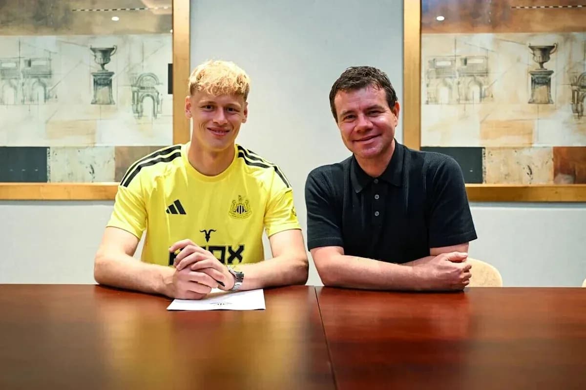 Player signing contract with club representative indoors Player signing contract with club representative indoors