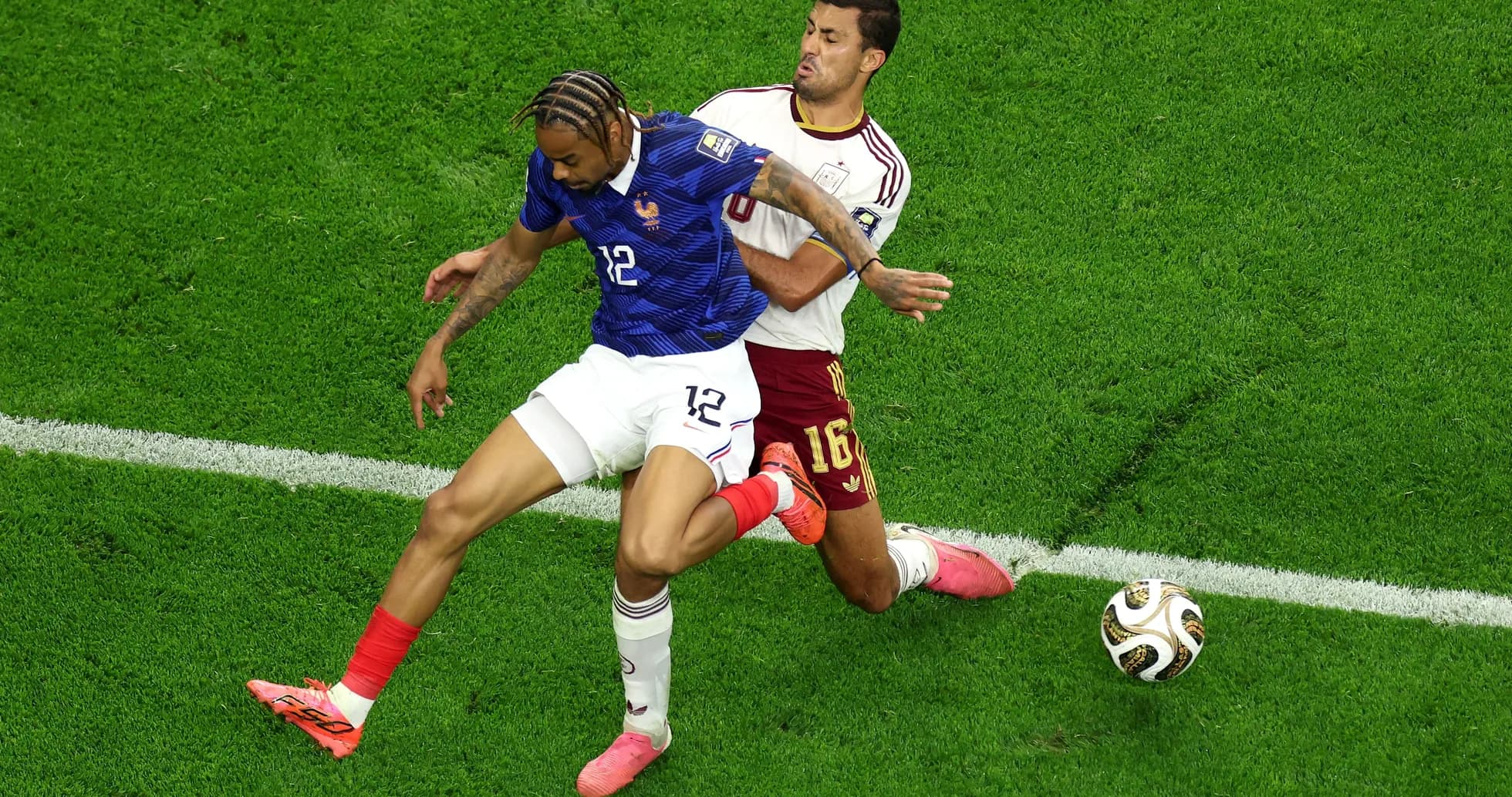 Two players contesting for the ball during match Two players contesting for the ball during match