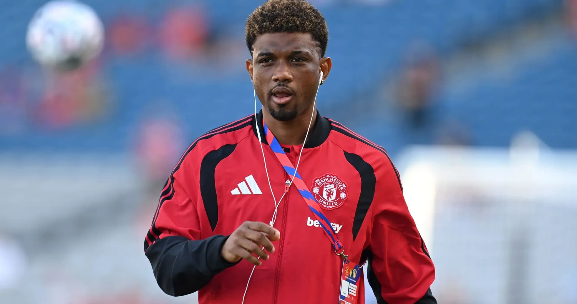 Player walking on pitch wearing Manchester United tracksuit Player walking on pitch wearing Manchester United tracksuit