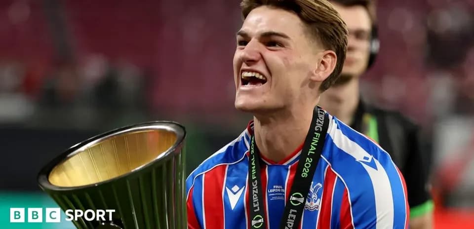Player celebrating with trophy after winning final Player celebrating with trophy after winning final
