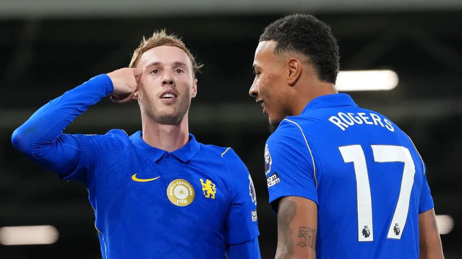 Two players celebrating a goal on the field Two players celebrating a goal on the field
