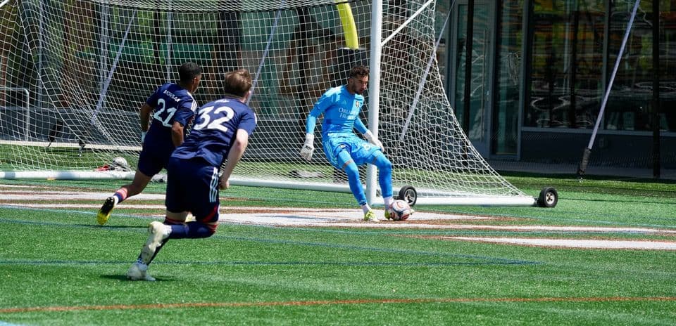 Goalkeeper preparing to save shot during match Goalkeeper preparing to save shot during match