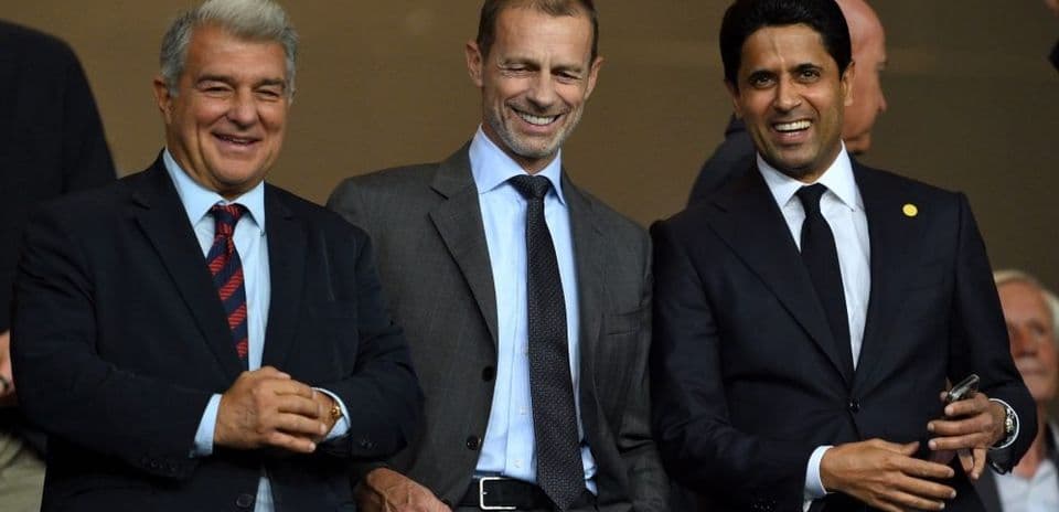 Three football executives smiling in a stadium box Three football executives smiling in a stadium box