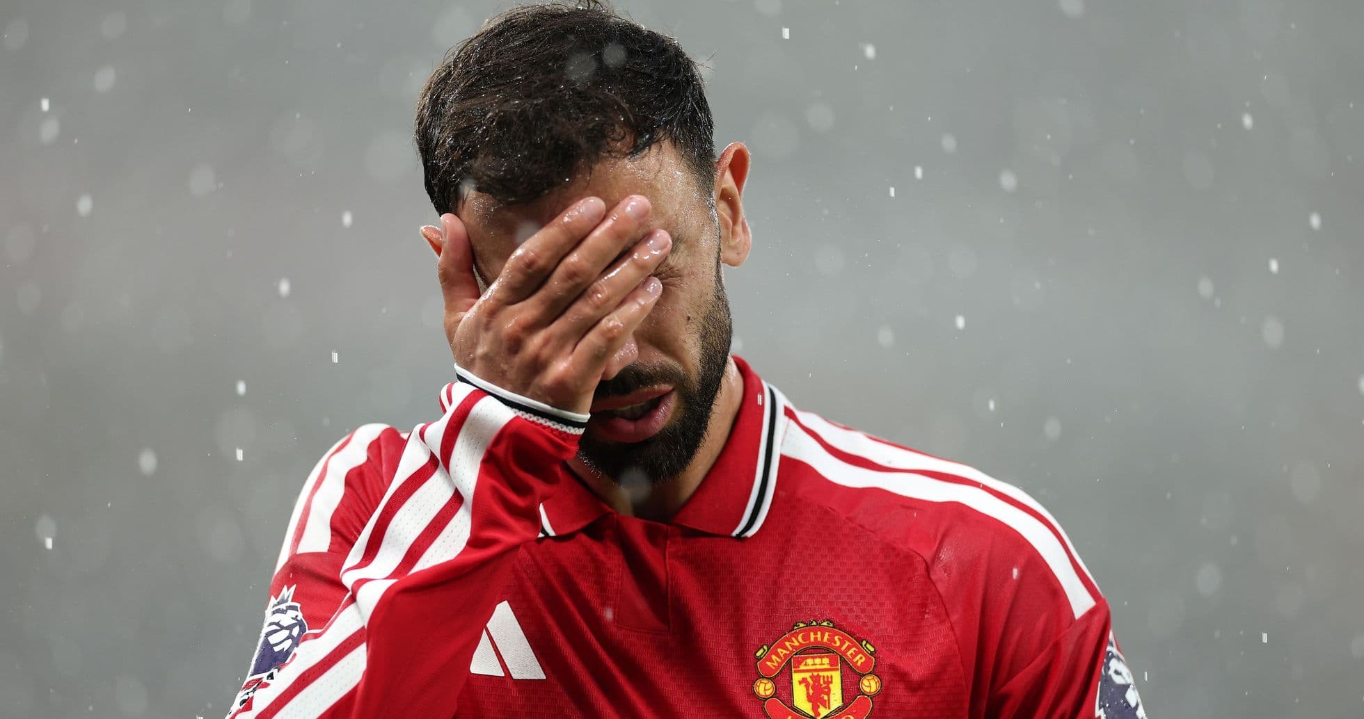 Player covering face during rain at match Player covering face during rain at match