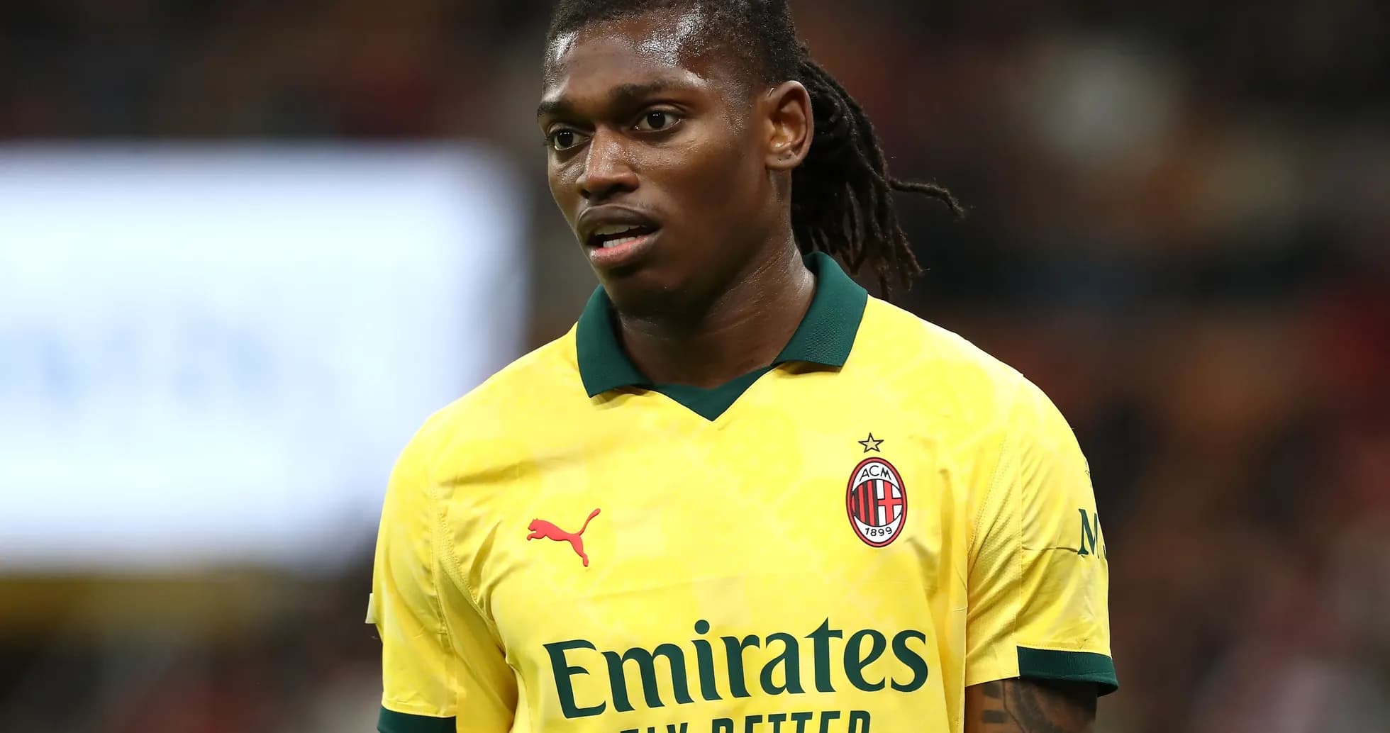 Player wearing yellow AC Milan jersey on field Player wearing yellow AC Milan jersey on field