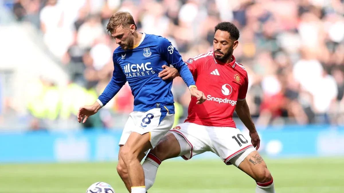 Everton player tackling Manchester United player during match Everton player tackling Manchester United player during match