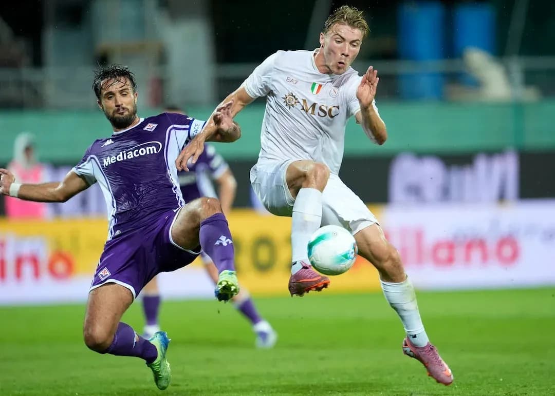 Fiorentina player tackling Napoli player during match Fiorentina player tackling Napoli player during match