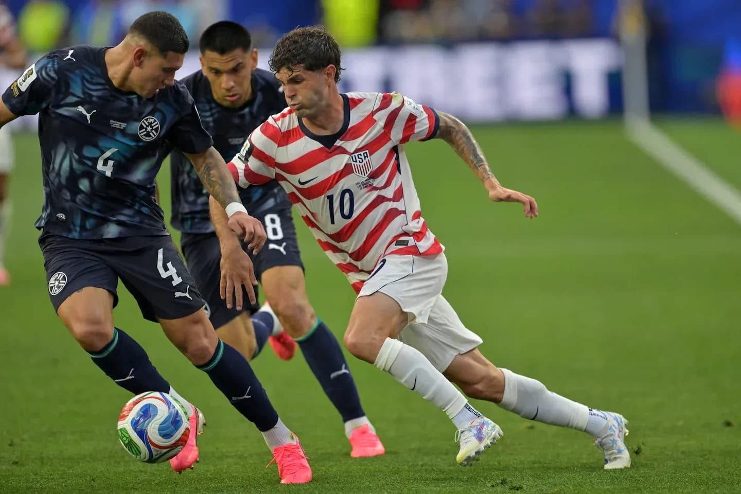 Two players contesting the ball during a match Two players contesting the ball during a match