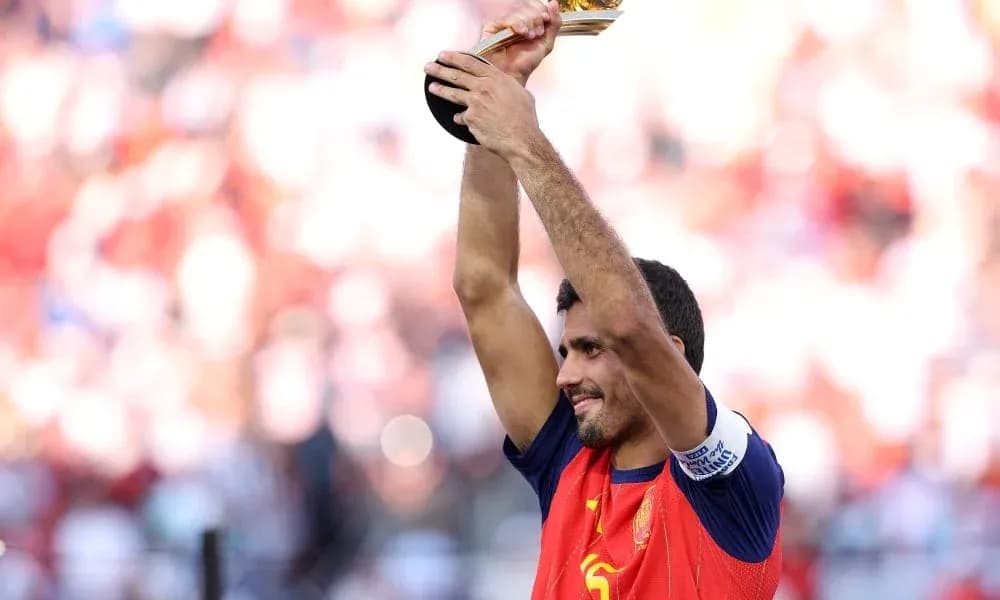 Player holding trophy aloft in celebration Player holding trophy aloft in celebration