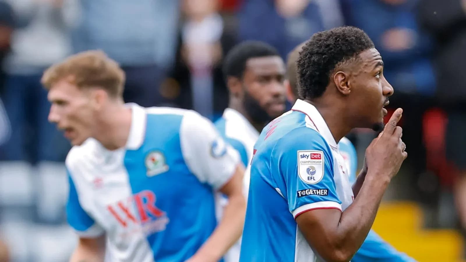 Player celebrating a goal with a finger to lips Player celebrating a goal with a finger to lips
