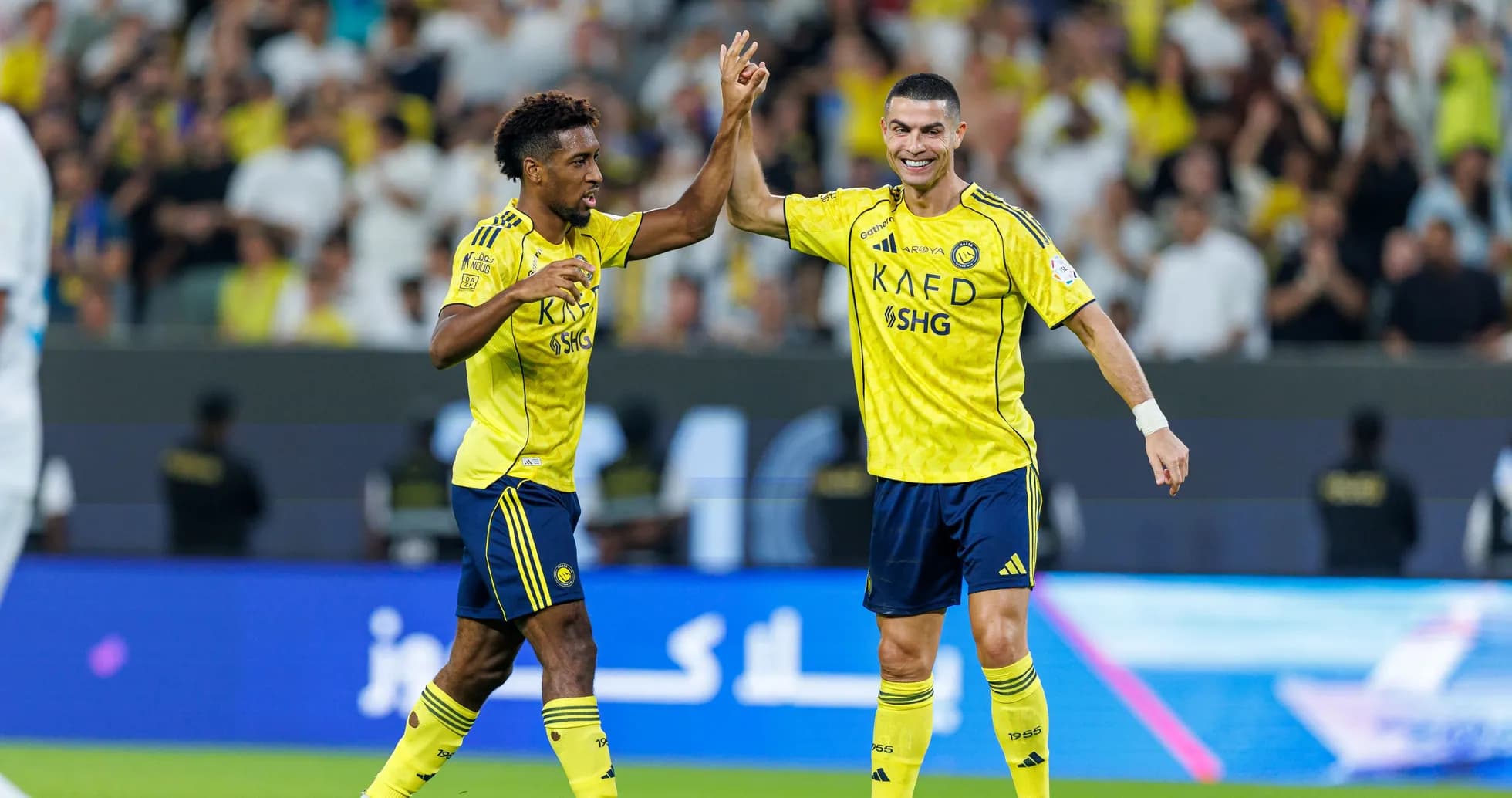 Two players celebrating a goal during match Two players celebrating a goal during match