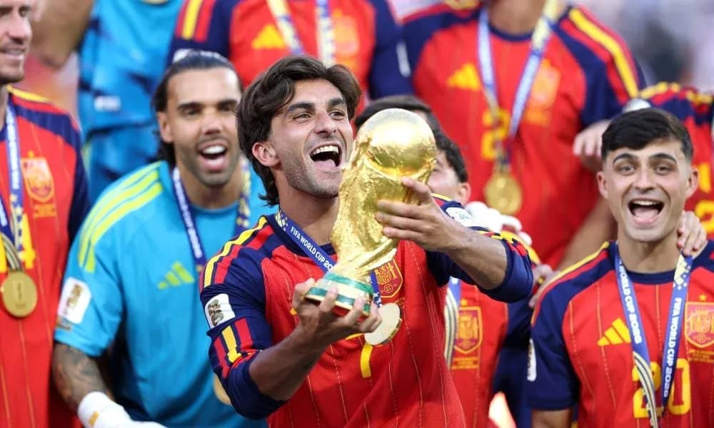 Player celebrating with FIFA World Cup trophy and teammates Player celebrating with FIFA World Cup trophy and teammates