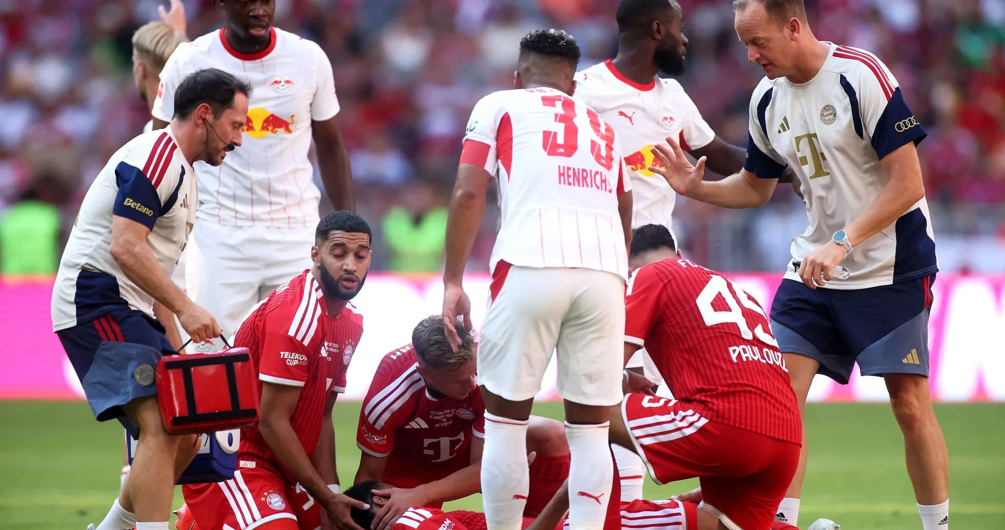 Players and medical staff attending to injured teammate Players and medical staff attending to injured teammate