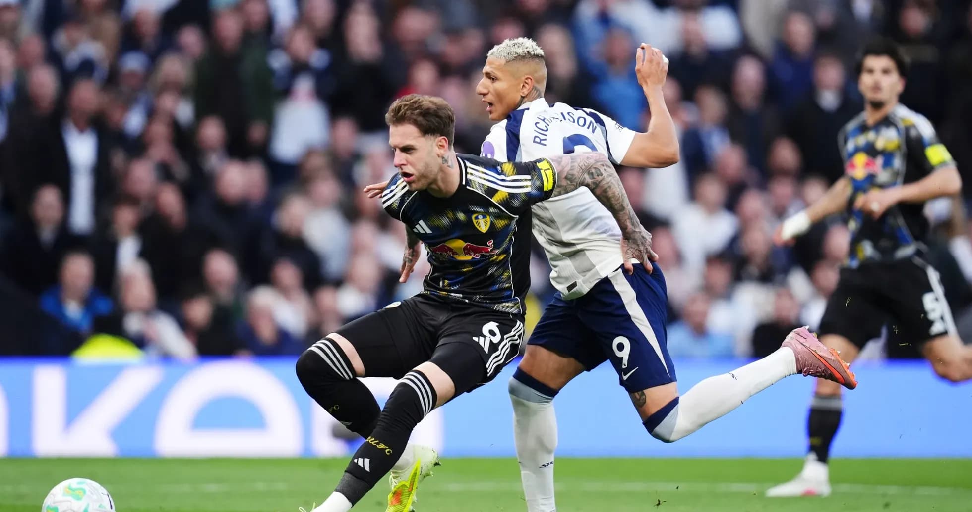 Leeds player tackled by Tottenham player Leeds player tackled by Tottenham player