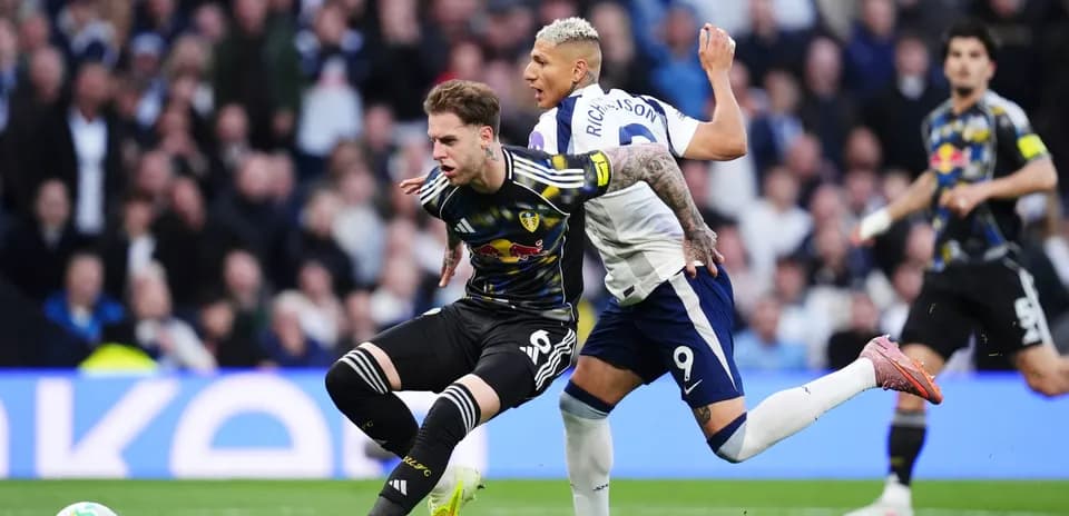 Leeds player tackled by Tottenham player Leeds player tackled by Tottenham player