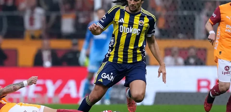 Fenerbahçe player evading a sliding tackle during match Fenerbahçe player evading a sliding tackle during match