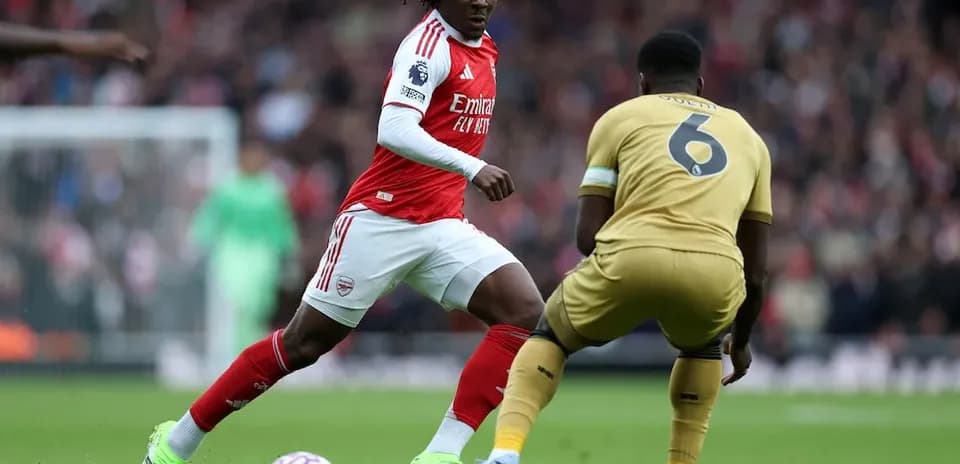 Arsenal player dribbling past Crystal Palace defender Arsenal player dribbling past Crystal Palace defender