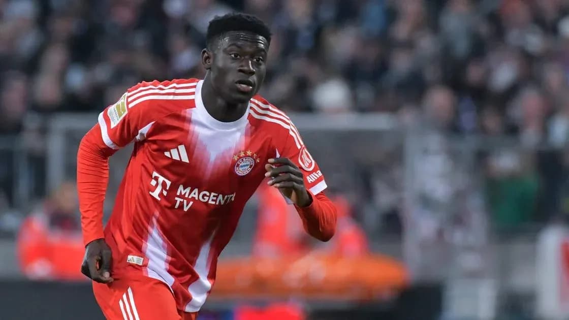 Player in Bayern Munich kit running on the pitch Player in Bayern Munich kit running on the pitch