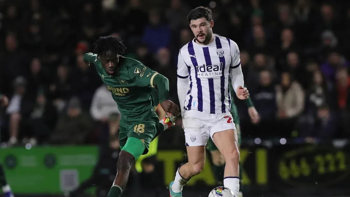 Player in green chasing player in white during match Player in green chasing player in white during match