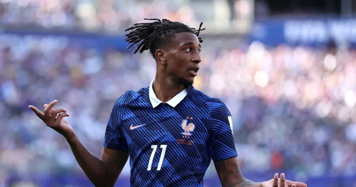 Player in blue France jersey gesturing on field Player in blue France jersey gesturing on field