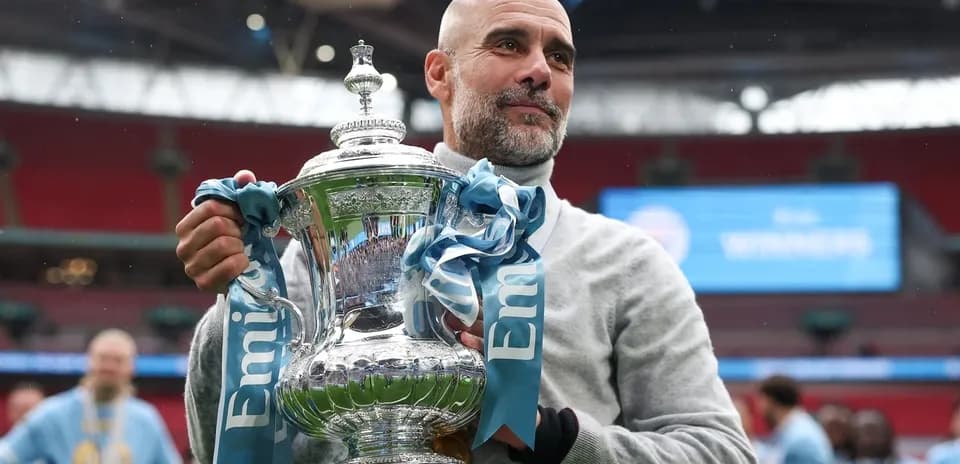 Coach holding trophy at stadium after victory Coach holding trophy at stadium after victory
