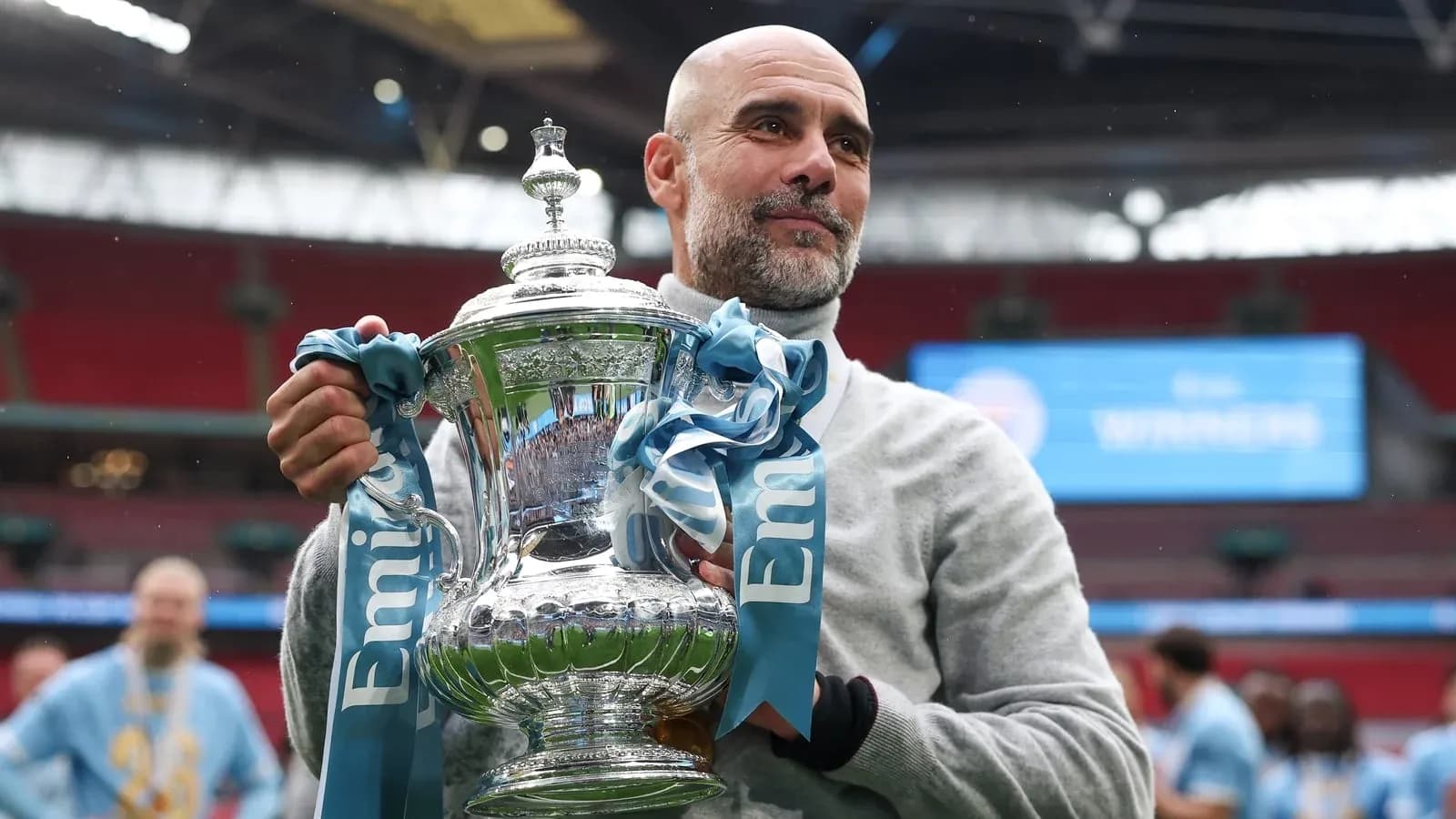 Coach holding trophy at stadium after victory Coach holding trophy at stadium after victory