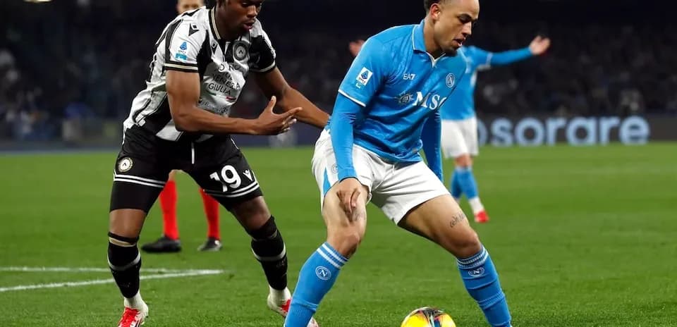 Napoli player challenged by Udinese opponent Napoli player challenged by Udinese opponent