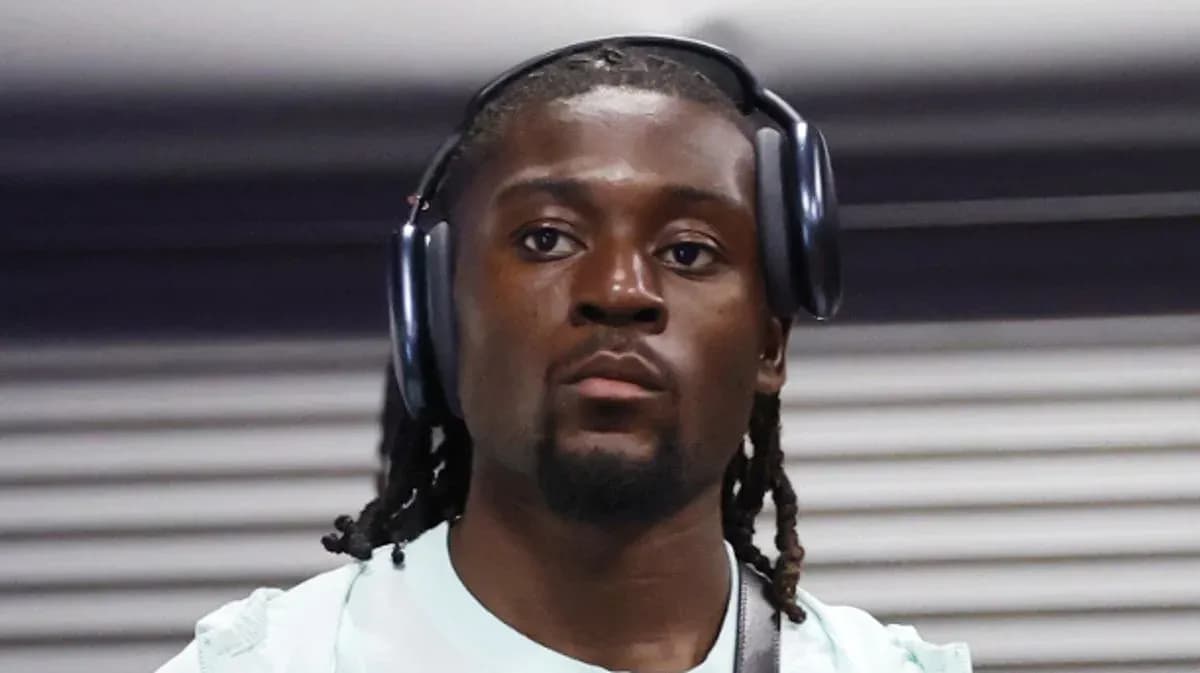 Athlete wearing headphones in a casual setting Athlete wearing headphones in a casual setting