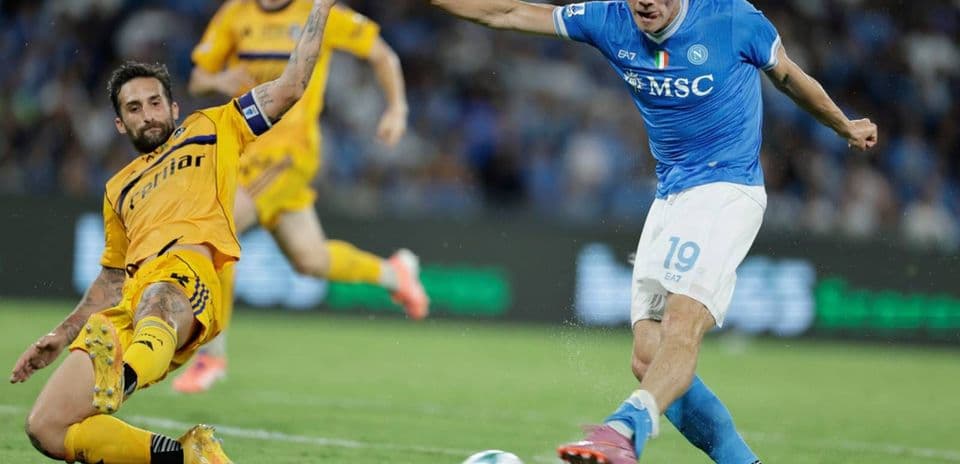 Napoli player dribbling past Pisa defender Napoli player dribbling past Pisa defender