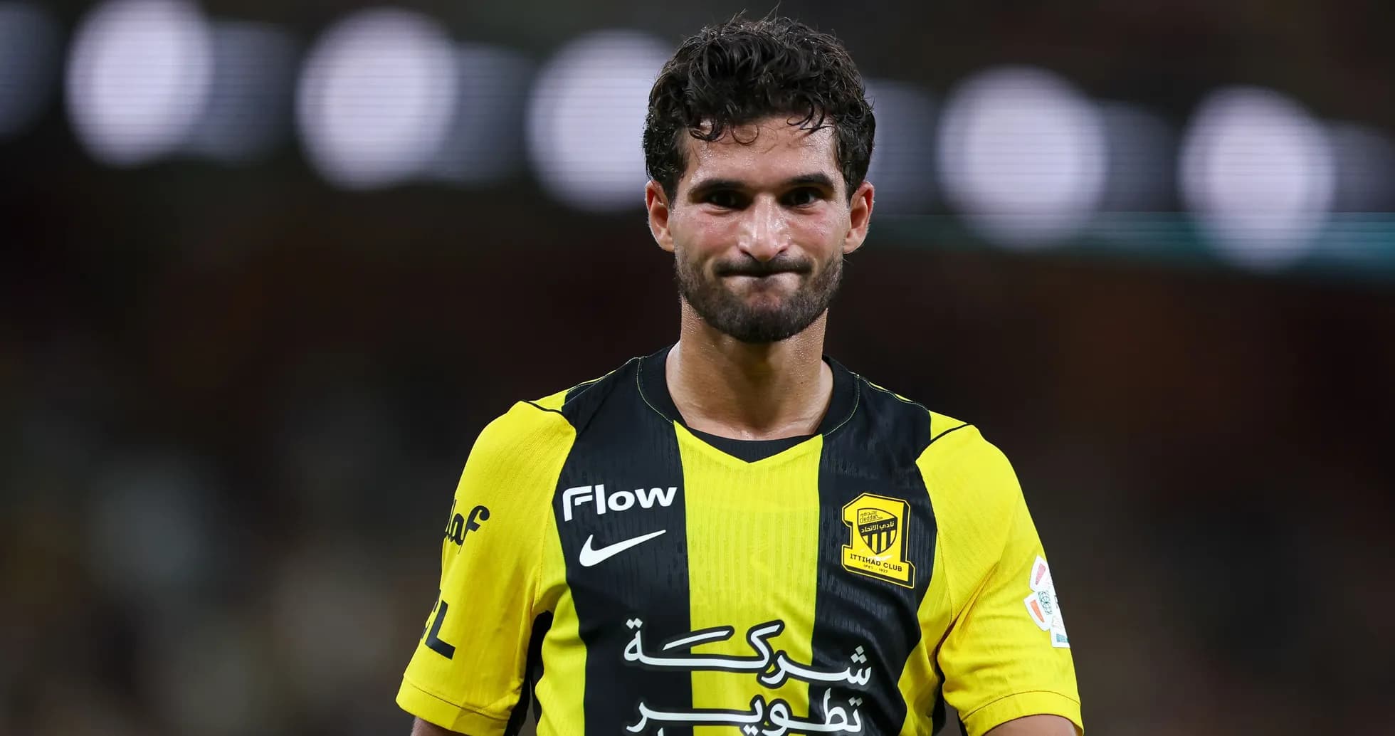 Player in yellow and black jersey during match Player in yellow and black jersey during match